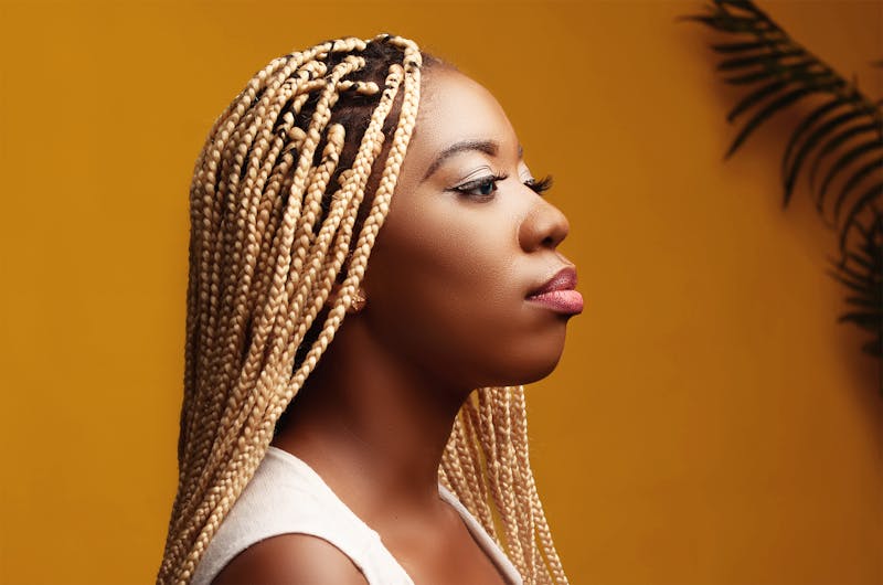 African American woman with long flowing braided extensions.